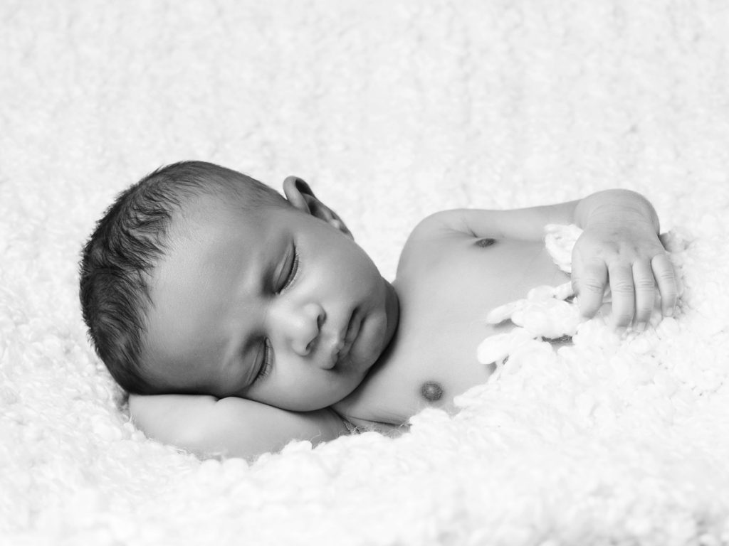 Baby boy peacefully sleeping during his photoshoot