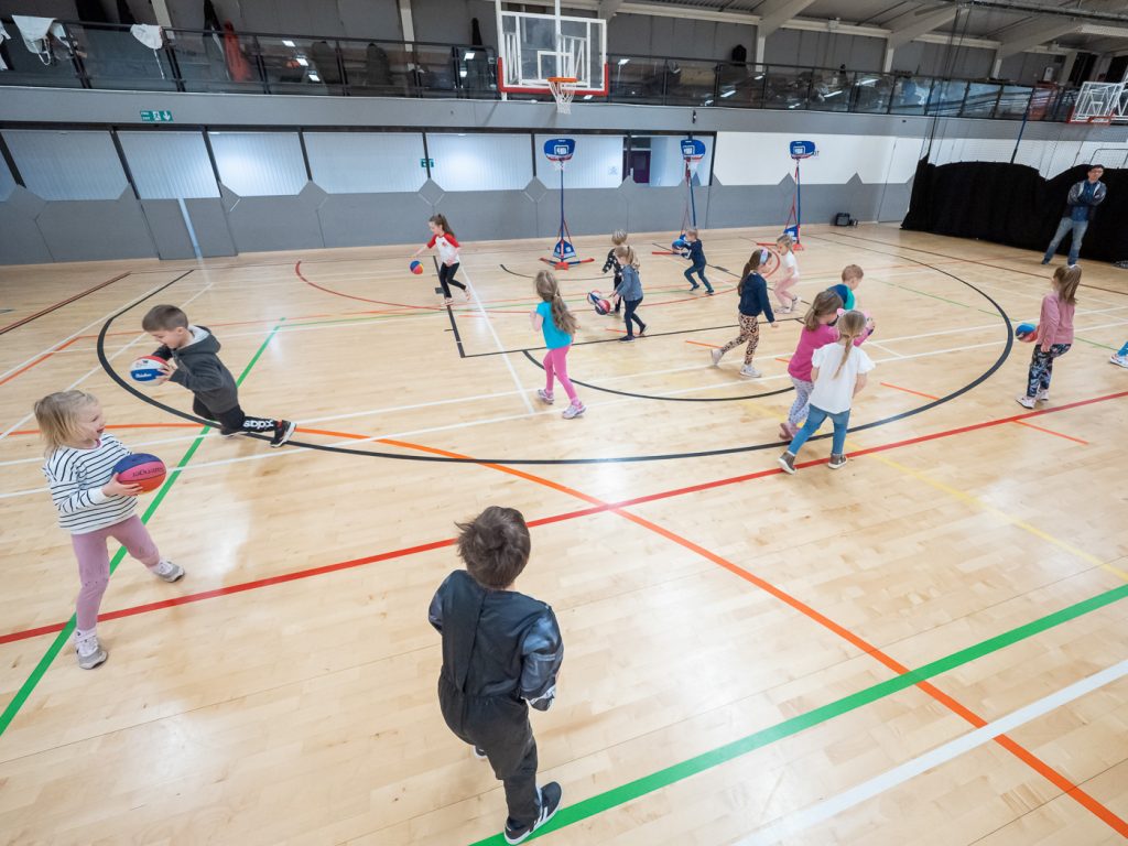 Photograph of children playing basketball at a Little Ballers training session.