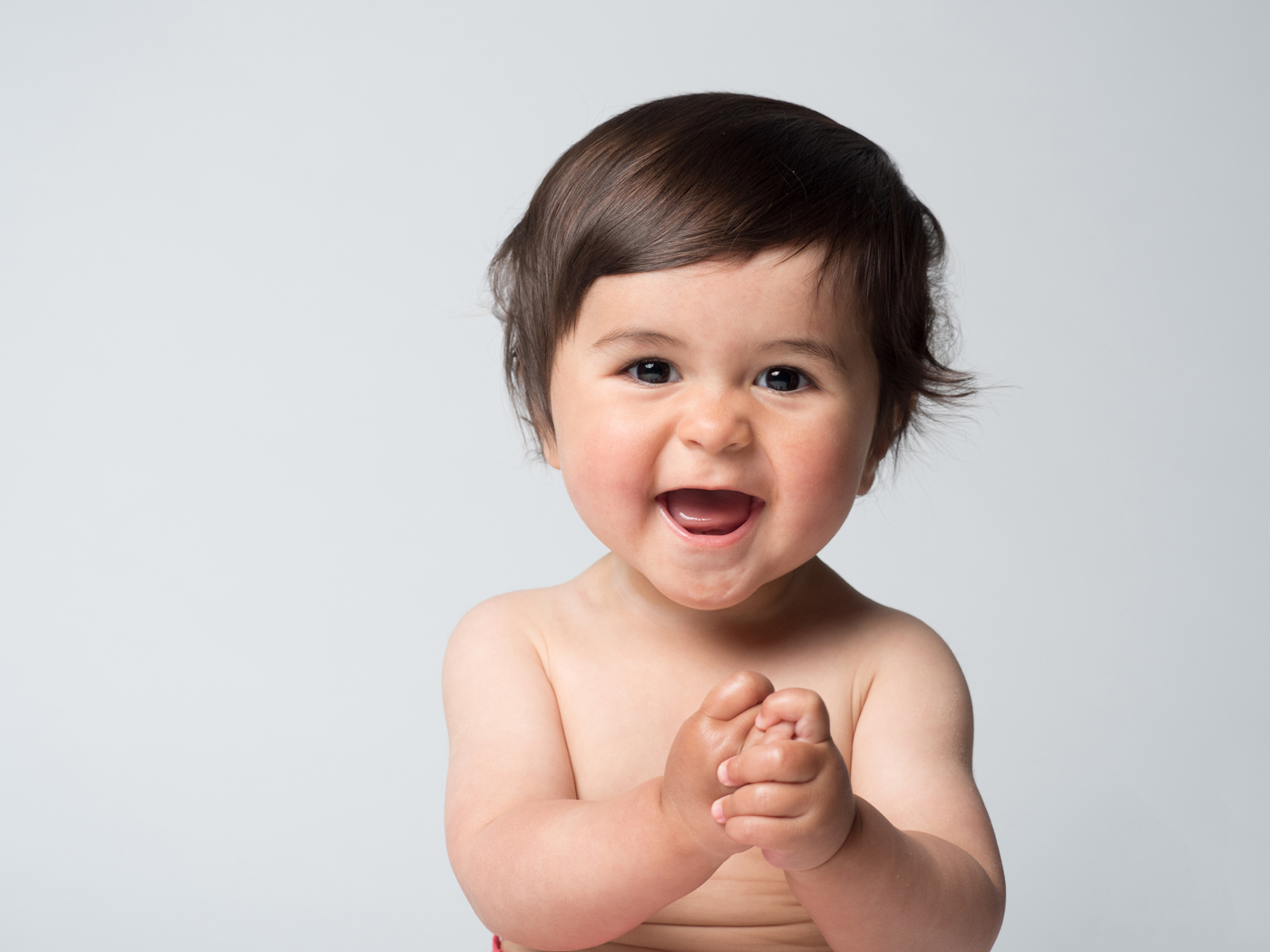 Picture of cute little boy with huge smile on his face during a photoshoot