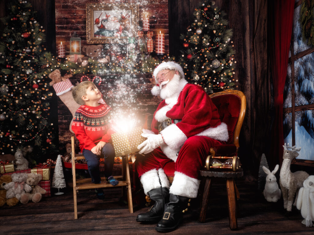 magical santa phootshoot with little boy seeing magic come out of the box