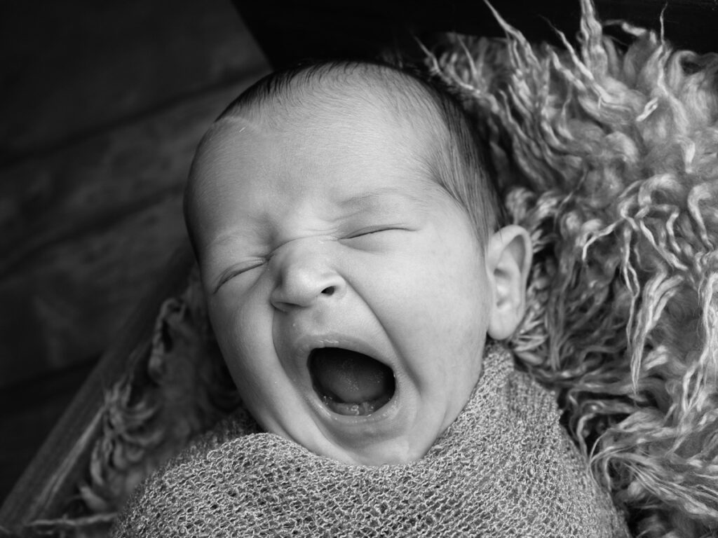 Photograph of a little baby having a yawn
