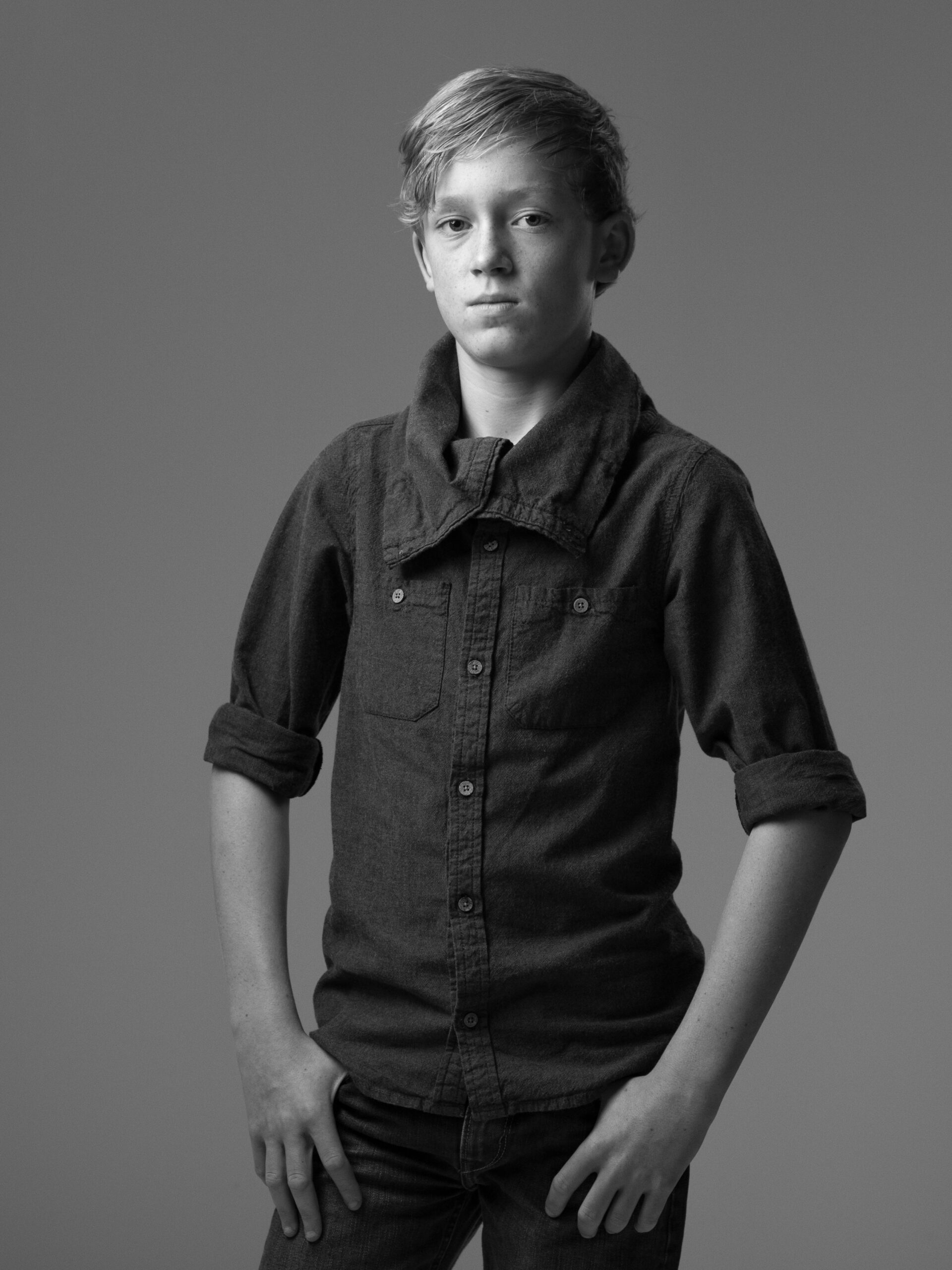 Black and white portrait of a boy in a denim shirt
