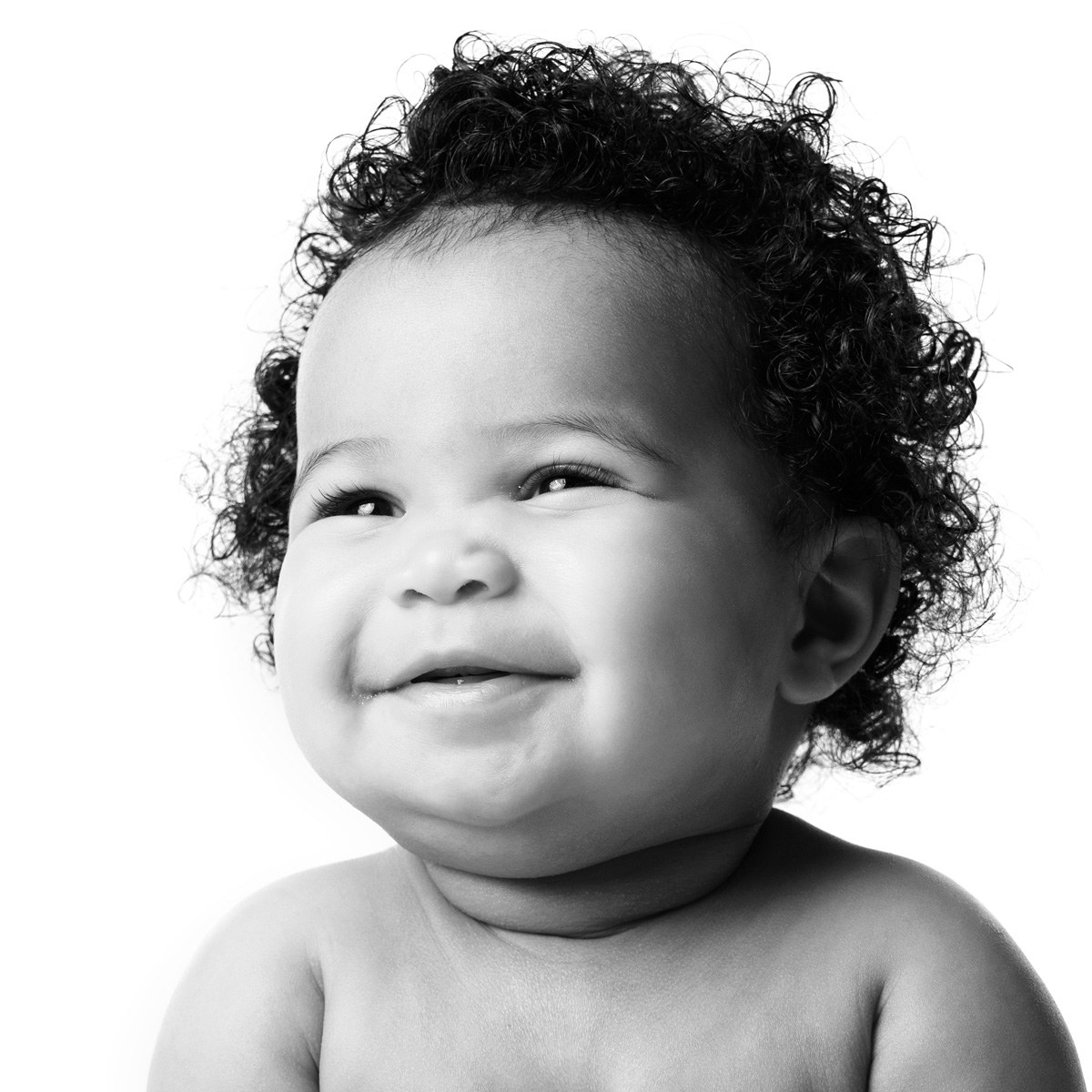 Smiling baby with curls, black and white