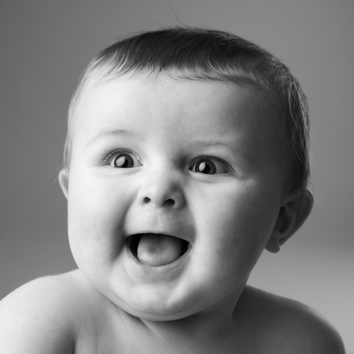 Excited, laughing baby, black and white