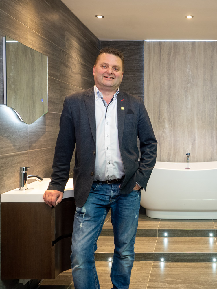 Personal branding portrait of a smiling businessman in his bathroom showroom