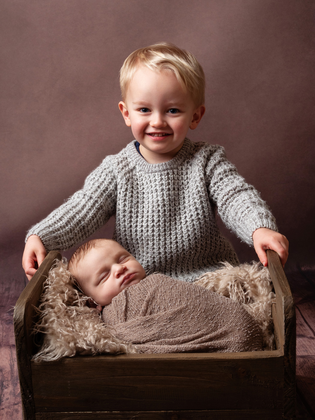 Big brother with his newborn sibling